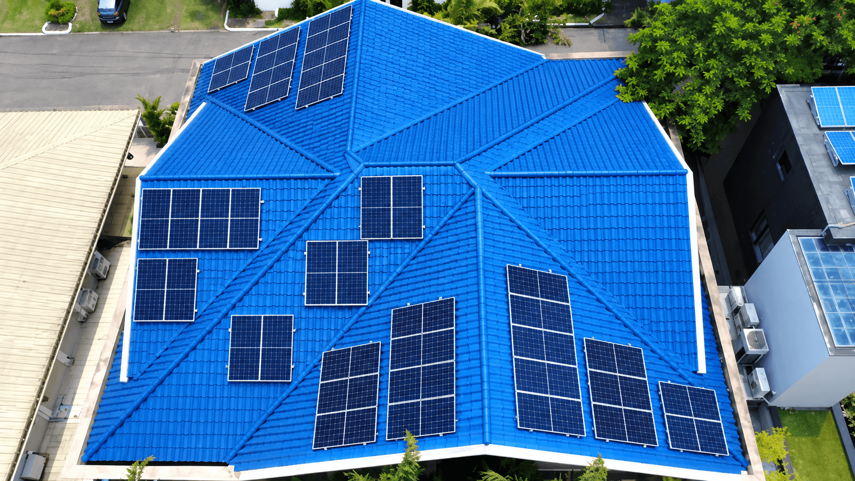 Aerial view of a house with a ground-mounted solar array